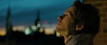 Movie still from “A Most Wanted Man” (2014), directed by Anton Corbijn – A person looking up at the sky; Close Up shot, Low angle