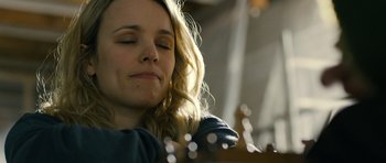 Movie still from “A Most Wanted Man” (2014), directed by Anton Corbijn – A beautiful woman sitting in front of a chessboard; Close Up shot, Over the shoulder angle