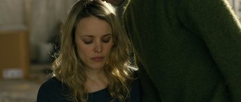 Movie still from “A Most Wanted Man” (2014), directed by Anton Corbijn – A woman with her eyes closed is being groomed by a man; Close Up shot, Overhead angle