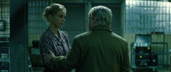 Movie still from “A Most Wanted Man” (2014), directed by Anton Corbijn – A man and a woman standing next to each other; Medium shot, Over the shoulder angle