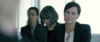 Movie still from “A Most Wanted Man” (2014), directed by Anton Corbijn – A group of women sitting in front of each other; Close Up shot, Over the shoulder angle