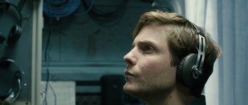 Movie still from “A Most Wanted Man” (2014), directed by Anton Corbijn – A person looking up at the sky; Close Up shot, Low angle