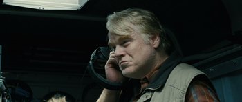 Movie still from “A Most Wanted Man” (2014), directed by Anton Corbijn – A man is talking on a cell phone while sitting in a car; Close Up shot, Low angle