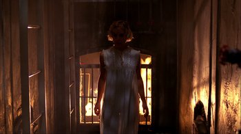 Movie still from “A Nightmare on Elm Street” (1984), directed by Wes Craven – A woman standing in front of an open fire place; Wide shot, Low angle