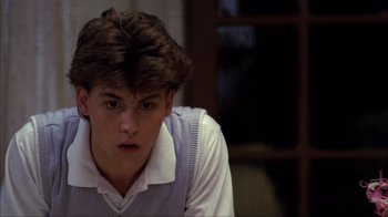 Movie still from “A Nightmare on Elm Street” (1984), directed by Wes Craven – A young man in a white shirt is looking at the camera; Close Up shot, Low angle