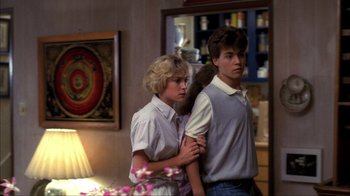 Movie still from “A Nightmare on Elm Street” (1984), directed by Wes Craven – A man and a woman standing next to each other in a room; Medium shot, Over the shoulder angle