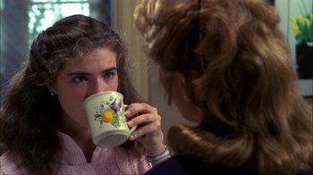 Movie still from “A Nightmare on Elm Street” (1984), directed by Wes Craven – A woman holding a mug in front of a mirror; Close Up shot, Over the shoulder angle
