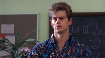 Movie still from “A Nightmare on Elm Street” (1984), directed by Wes Craven – A young man wearing a blue and orange patterned shirt; Close Up shot, Over the shoulder angle