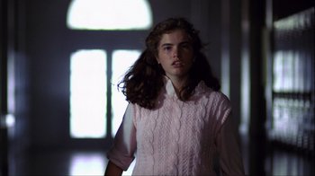 Movie still from “A Nightmare on Elm Street” (1984), directed by Wes Craven – A woman in a white shirt and a pink sweater; Medium shot, Low angle