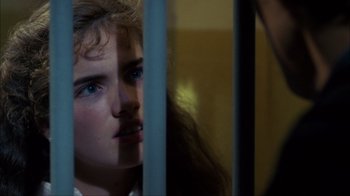 Movie still from “A Nightmare on Elm Street” (1984), directed by Wes Craven – A young woman looking through a window at a person; Close Up shot, Over the shoulder angle