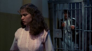 Movie still from “A Nightmare on Elm Street” (1984), directed by Wes Craven – A woman standing in front of a jail cell; Medium shot, Over the shoulder angle