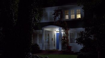 Movie still from “A Nightmare on Elm Street” (1984), directed by Wes Craven – A night time picture of a house with a blue door; Wide shot, Low angle
