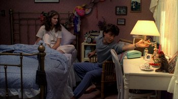 Movie still from “A Nightmare on Elm Street” (1984), directed by Wes Craven – Two people sitting in a room next to each other; Wide shot, High angle