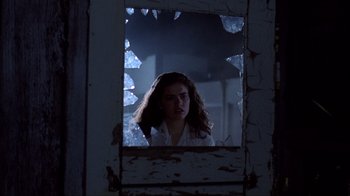 Movie still from “A Nightmare on Elm Street” (1984), directed by Wes Craven – A woman is looking into a broken mirror; Close Up shot, Low angle