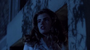 Movie still from “A Nightmare on Elm Street” (1984), directed by Wes Craven – A woman with long curly hair looking up at the sky; Close Up shot, Low angle