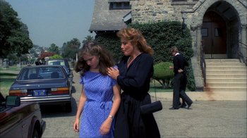 Movie still from “A Nightmare on Elm Street” (1984), directed by Wes Craven – A woman and a young girl walking down a street; Medium shot, Over the shoulder angle