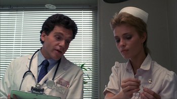 Movie still from “A Nightmare on Elm Street” (1984), directed by Wes Craven – A man and a woman in a doctors office; Close Up shot, Low angle