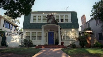 Movie still from “A Nightmare on Elm Street” (1984), directed by Wes Craven – A large white house with a blue door; Extreme Wide shot, Low angle