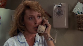 Movie still from “A Nightmare on Elm Street” (1984), directed by Wes Craven – A woman talking on a phone in a room; Close Up shot, Low angle