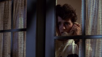 Movie still from “A Nightmare on Elm Street” (1984), directed by Wes Craven – A man holding a phone up to his ear; Close Up shot, Low angle
