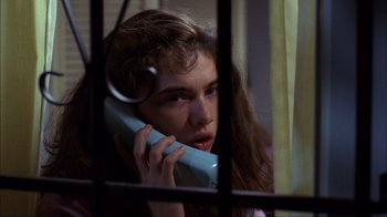 Movie still from “A Nightmare on Elm Street” (1984), directed by Wes Craven – A woman holding a phone up to her ear; Close Up shot, High angle