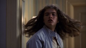 Movie still from “A Nightmare on Elm Street” (1984), directed by Wes Craven – A woman with long hair is standing in a room; Close Up shot, Low angle