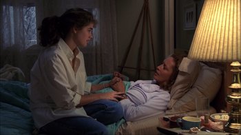 Movie still from “A Nightmare on Elm Street” (1984), directed by Wes Craven – Two women sitting on a bed talking to each other; Medium shot, High angle