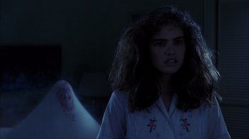 Movie still from “A Nightmare on Elm Street” (1984), directed by Wes Craven – A young woman standing in front of a blurry ghost; Close Up shot, Over the shoulder angle