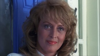 Movie still from “A Nightmare on Elm Street” (1984), directed by Wes Craven – A woman's face in front of a blue door; Close Up shot, Low angle