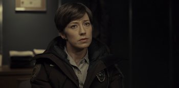 Movie still from “Fargo” (2014), created by Noah Hawley – A woman in a brown jacket is looking to her left; Close Up shot, Over the shoulder angle
