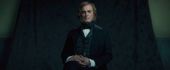 A man in a black suit and a white shirt