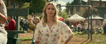 Movie still from “A Quiet Place Part II” (2020), directed by John Krasinski – A woman standing in front of other people in a park; Medium shot, Over the shoulder angle