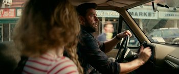 Movie still from “A Quiet Place Part II” (2020), directed by John Krasinski – A man and a woman in a car driving; Medium shot, Over the shoulder angle