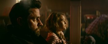 Movie still from “A Quiet Place Part II” (2020), directed by John Krasinski – A man and a woman sitting next to each other in a room; Close Up shot, Over the shoulder angle