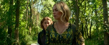 Movie still from “A Quiet Place Part II” (2020), directed by John Krasinski – A woman and a child are standing in a forest; Medium shot, Over the shoulder angle