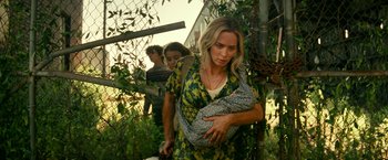 Movie still from “A Quiet Place Part II” (2020), directed by John Krasinski – A group of people walking through a fence; Medium shot, Low angle