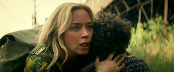 Movie still from “A Quiet Place Part II” (2020), directed by John Krasinski – A woman is holding a dog in her arms; Close Up shot, Over the shoulder angle