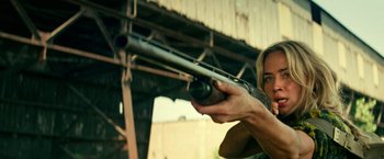 Movie still from “A Quiet Place Part II” (2020), directed by John Krasinski – A woman is holding a gun in her hand; Close Up shot, Over the shoulder angle