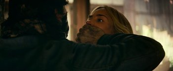 Movie still from “A Quiet Place Part II” (2020), directed by John Krasinski – A man and a woman with their mouths taped shut; Close Up shot, Over the shoulder angle