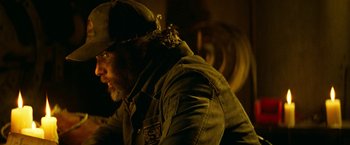 Movie still from “A Quiet Place Part II” (2020), directed by John Krasinski – A man with a beard wearing a hat and a jacket; Close Up shot, Over the shoulder angle