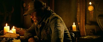 Movie still from “A Quiet Place Part II” (2020), directed by John Krasinski – A man with a beard wearing a hat and jacket; Medium shot, Low angle