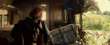 Movie still from “A Quiet Place Part II” (2020), directed by John Krasinski – A woman standing in a room with a suitcase; Medium shot, Low angle