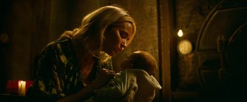 Movie still from “A Quiet Place Part II” (2020), directed by John Krasinski – A woman holding a baby in her arms; Close Up shot, Over the shoulder angle