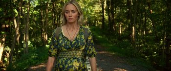 Movie still from “A Quiet Place Part II” (2020), directed by John Krasinski – A woman in a dress standing on a path in the woods; Medium shot, Low angle
