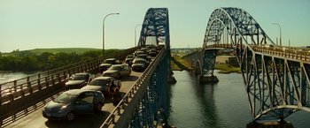 Movie still from “A Quiet Place Part II” (2020), directed by John Krasinski – Cars are parked on a bridge over a river; Extreme Wide shot, High angle