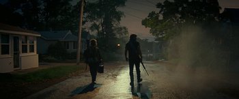 Movie still from “A Quiet Place Part II” (2020), directed by John Krasinski – Two people walking down a street at night; Wide shot, Low angle
