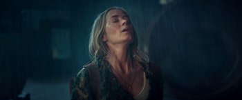 Movie still from “A Quiet Place Part II” (2020), directed by John Krasinski – A woman with her eyes closed in the rain; Close Up shot, Low angle