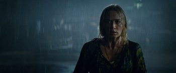 Movie still from “A Quiet Place Part II” (2020), directed by John Krasinski – A woman standing in the middle of the street in the rain; Close Up shot, Low angle
