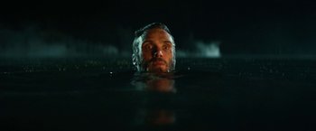 Movie still from “A Quiet Place Part II” (2020), directed by John Krasinski – A man in the water looking up at the sky; Close Up shot, Low angle