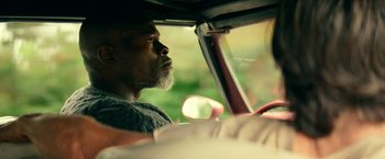 Movie still from “A Quiet Place Part II” (2020), directed by John Krasinski – A man sitting in the driver's seat of a car; Close Up shot, Low angle